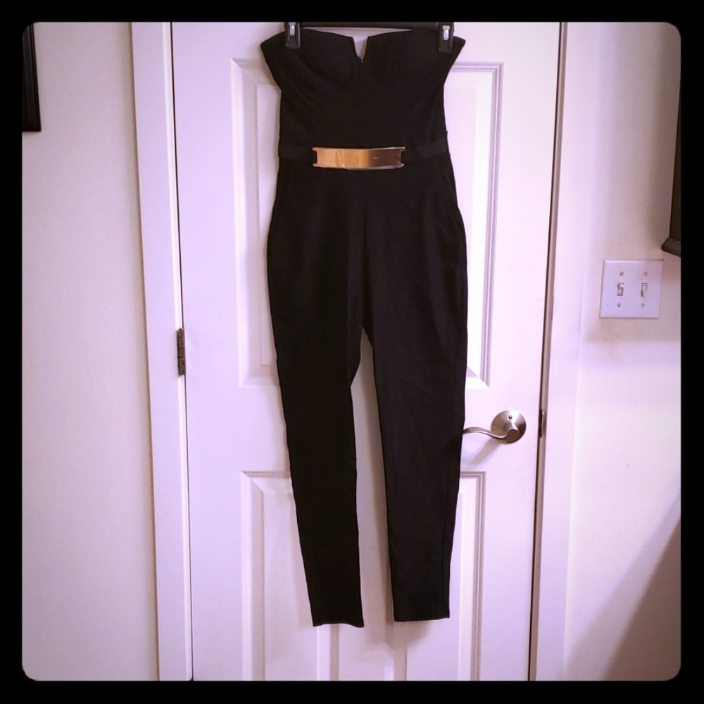 Black sleeveless mid calf jumpsuit  gold belt.